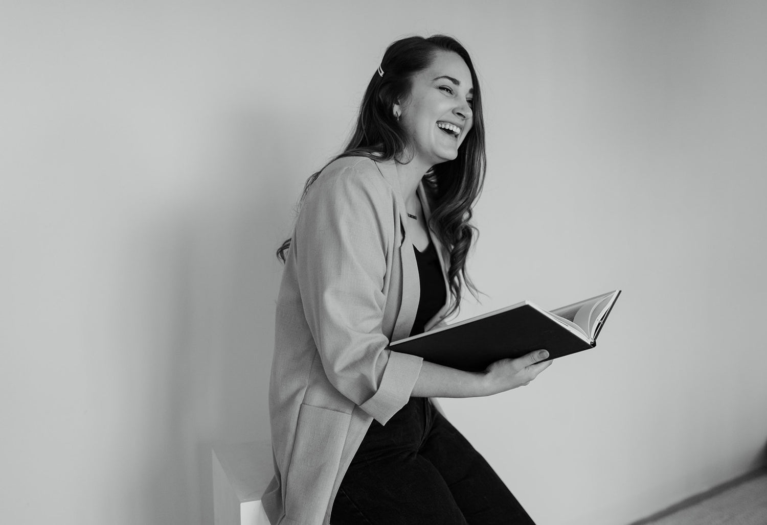 owner jess lynne holding floral book