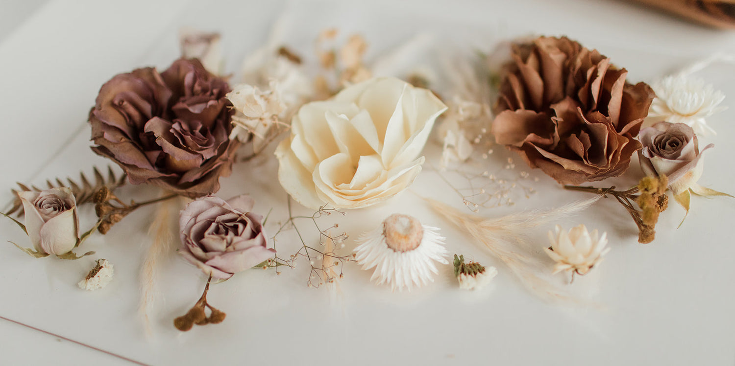 Preserved flowers loosely laid out on glass