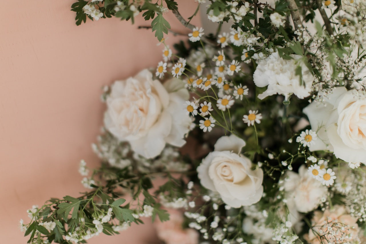 white rose and chamomile flower arrangement